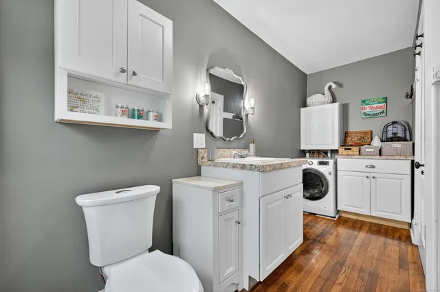 a bathroom with a toilet sink and mirror