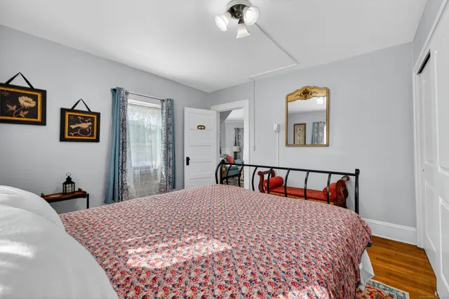 a bedroom with a bed and a painting on the wall