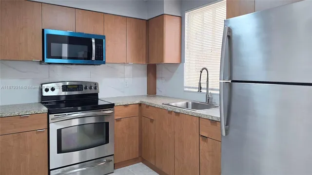 a kitchen with a sink and a microwave