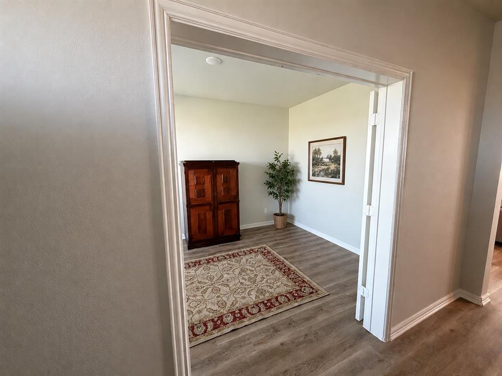 131 Llanos Drive Decatur, TX 76234 - Photo 2 of 9 Room entrance featuring light-toned wood-finish flooring and neutral wall tones