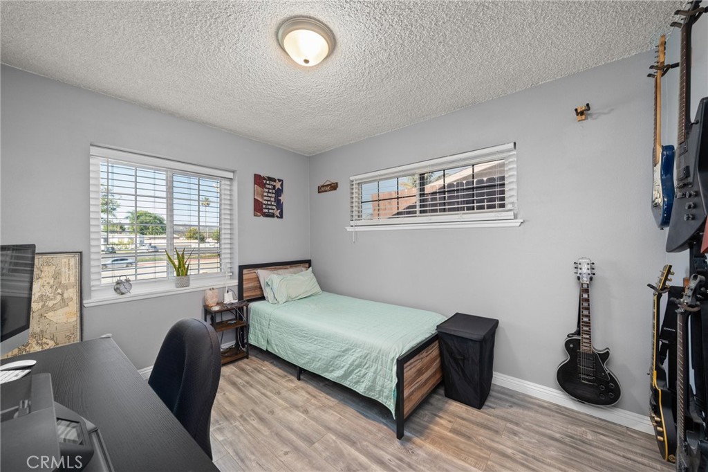 15326 Leffingwell Road Whittier, CA 90604 - Photo 13 of 20 a bedroom with a bed and a flat tv screen on the dresser
