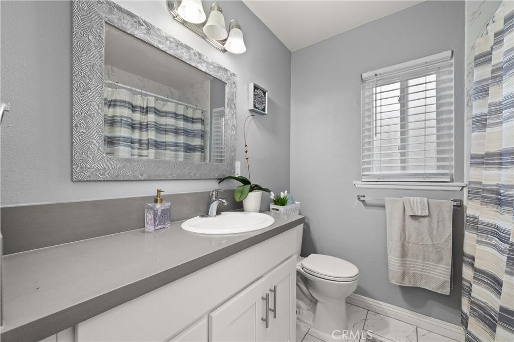 15326 Leffingwell Road Whittier, CA 90604 - Photo 15 of 20 a bathroom with a sink a toilet and mirror
