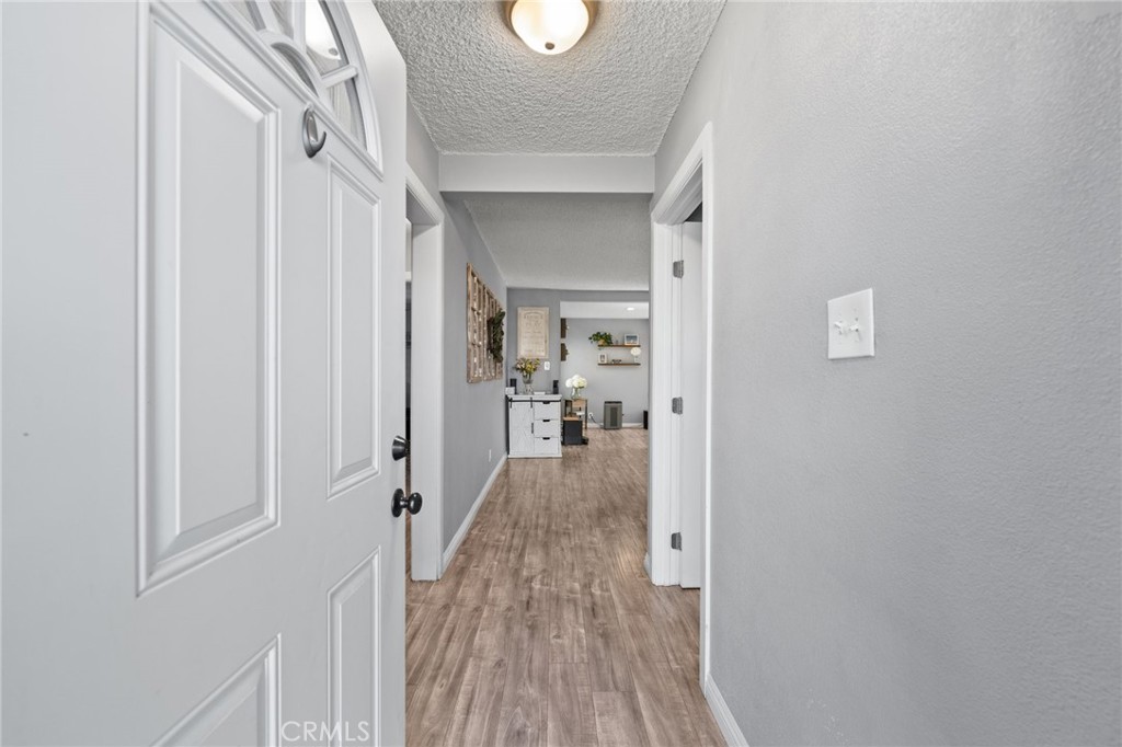 15326 Leffingwell Road Whittier, CA 90604 - Photo 5 of 20 a view of a hallway with wooden floor and staircase
