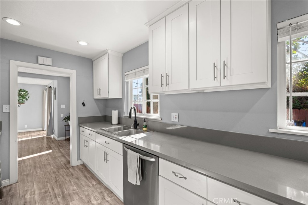 15326 Leffingwell Road Whittier, CA 90604 - Photo 8 of 20 a kitchen with granite countertop a sink stainless steel appliances white cabinets and a window