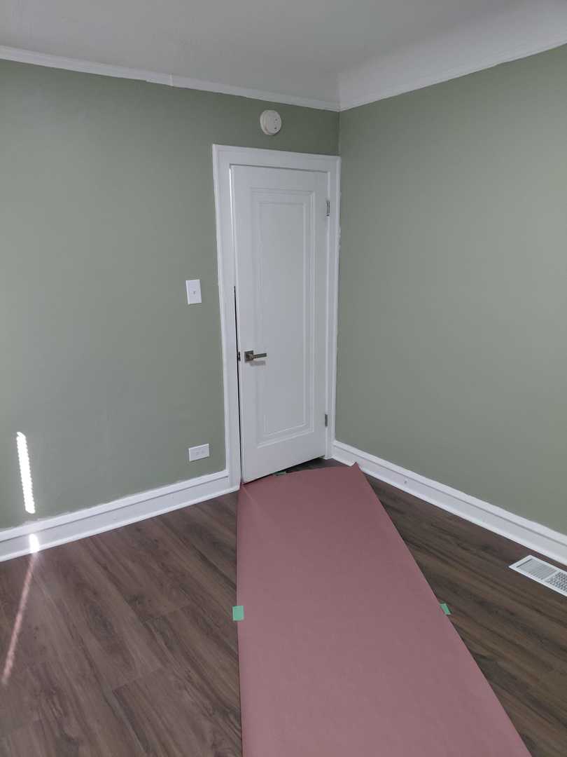 1040 West 92nd Place Chicago, IL 60620 - Photo 11 of 29 a view of an empty room with wooden floor