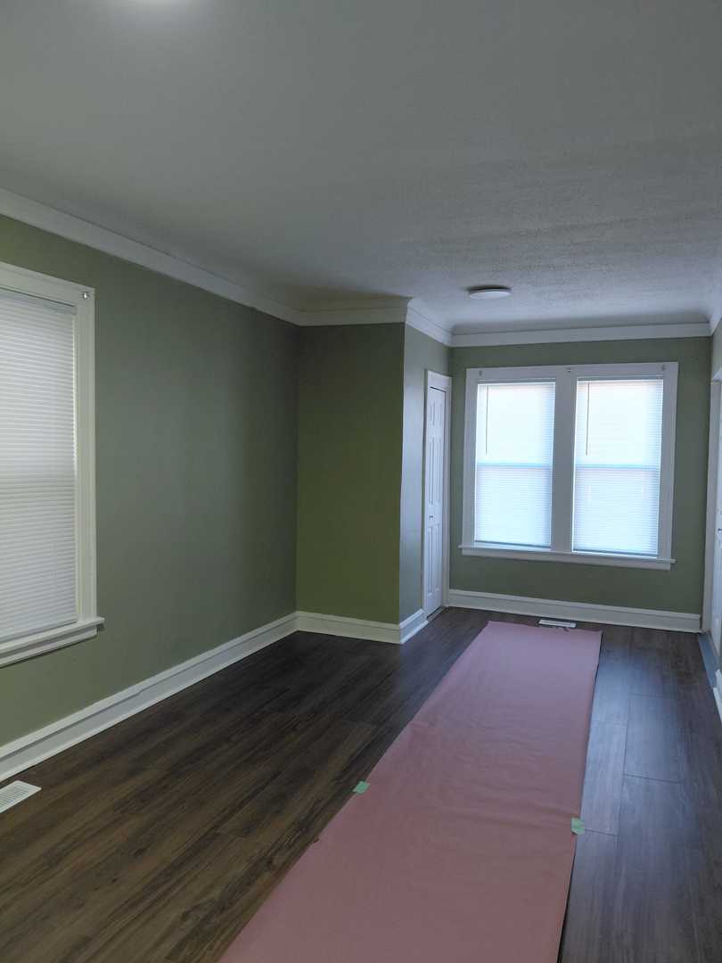 1040 West 92nd Place Chicago, IL 60620 - Photo 14 of 29 an empty room with wooden floor and windows