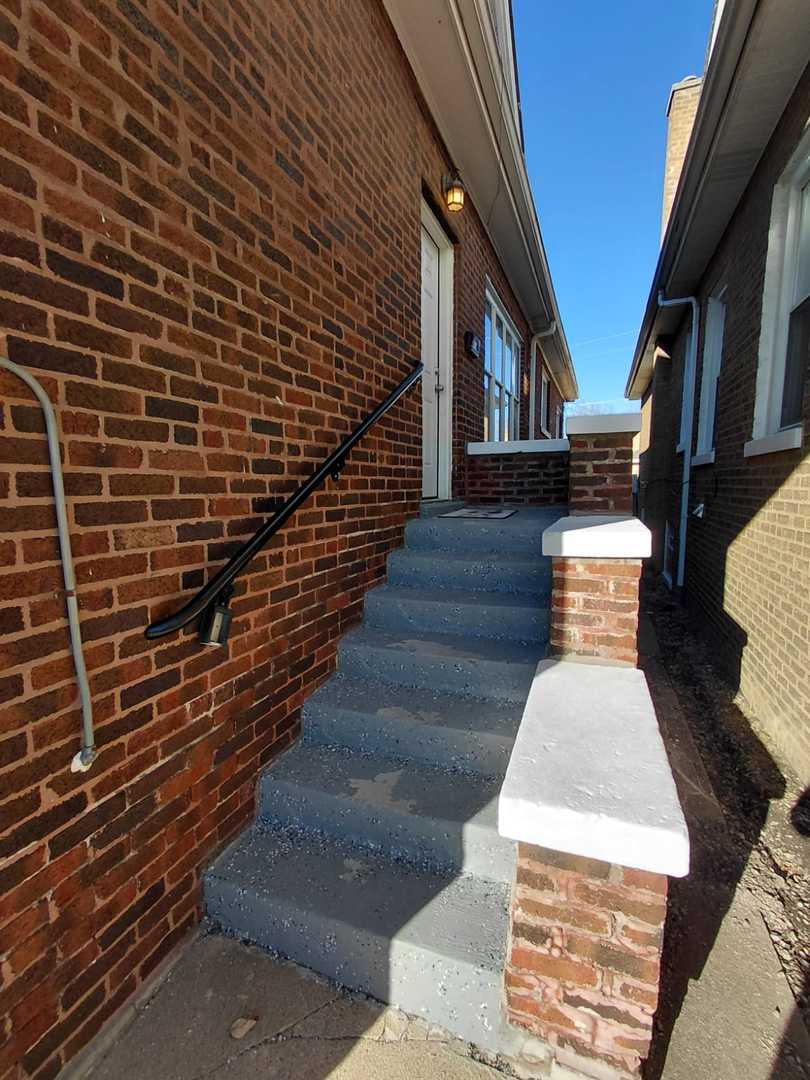 1040 West 92nd Place Chicago, IL 60620 - Photo 3 of 29 a bathroom with a toilet and a shower