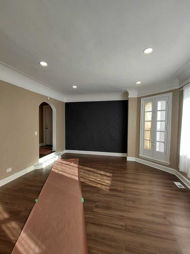 1040 West 92nd Place Chicago, IL 60620 - Photo 4 of 29 a view of an empty room with window and wooden floor