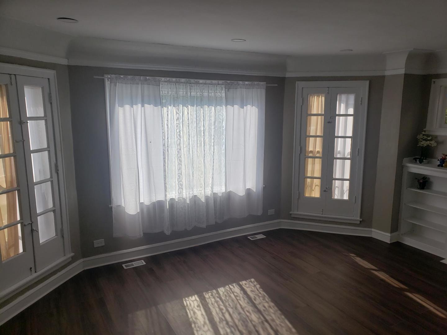 1040 West 92nd Place Chicago, IL 60620 - Photo 6 of 29 an empty room with wooden floor and windows