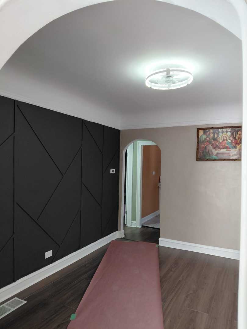 1040 West 92nd Place Chicago, IL 60620 - Photo 7 of 29 an empty room with wooden floor closet and windows