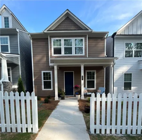 a view of a house with wooden fence