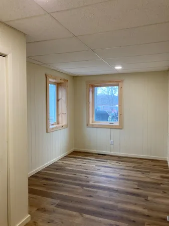 a view of a room with wooden floor and window