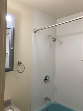 a bathroom with a granite countertop mirror a vanity and a shower
