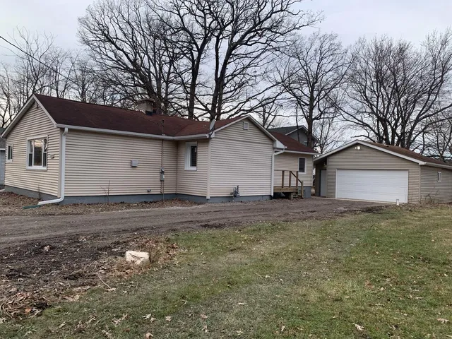 a view of a house with a yard covered in the tree