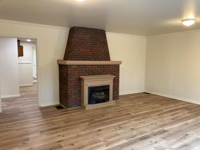 a living room with a fireplace furniture and a wooden floor