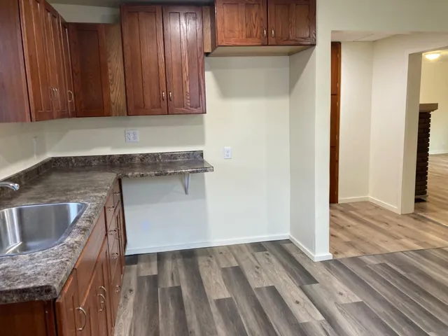 a utility room with wooden floor washer and dryer