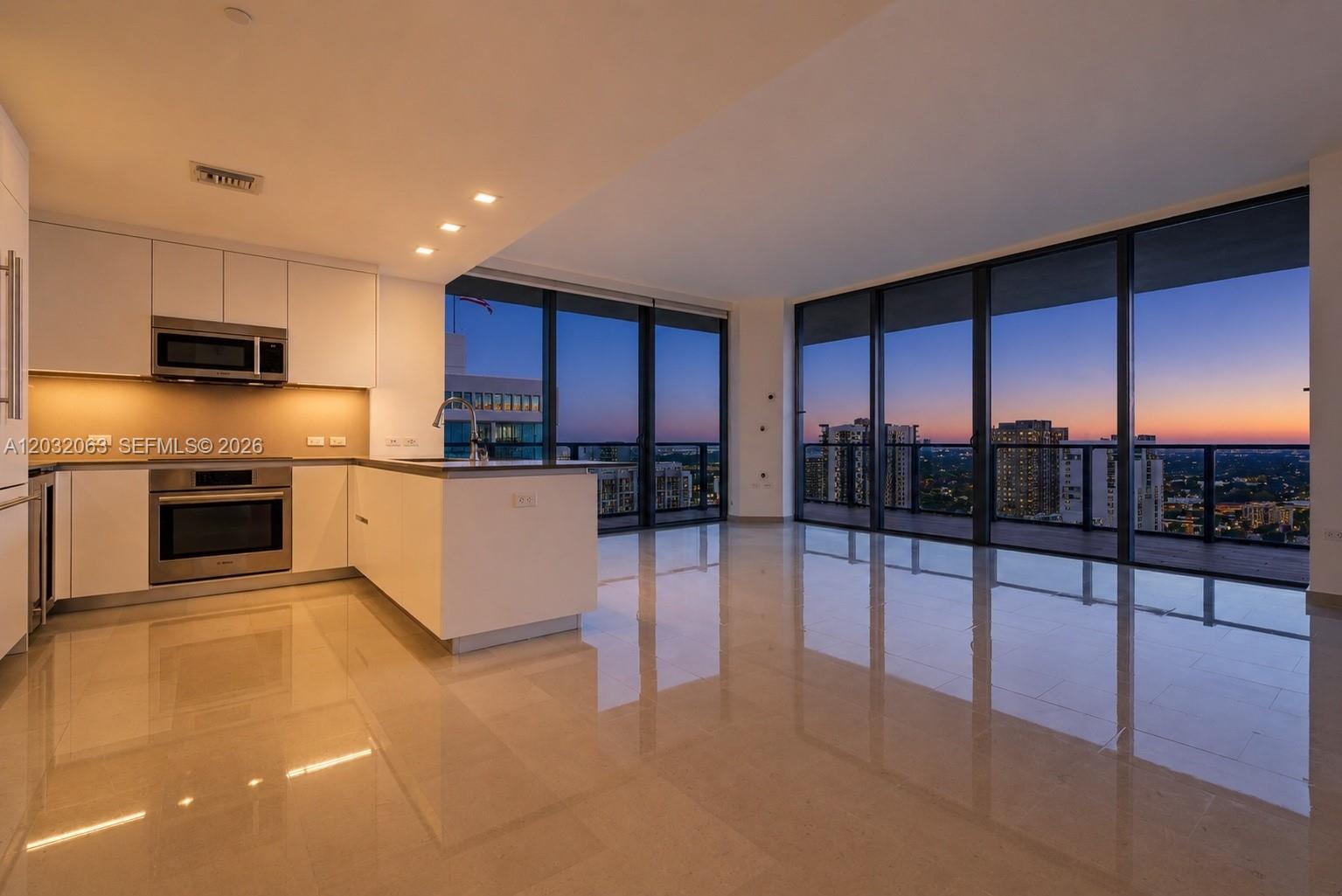 88 Southwest 7th Street, Unit 2302 Miami, FL 33130 - Photo 1 of 26 a kitchen with stainless steel appliances granite countertop a refrigerator sink and cabinets