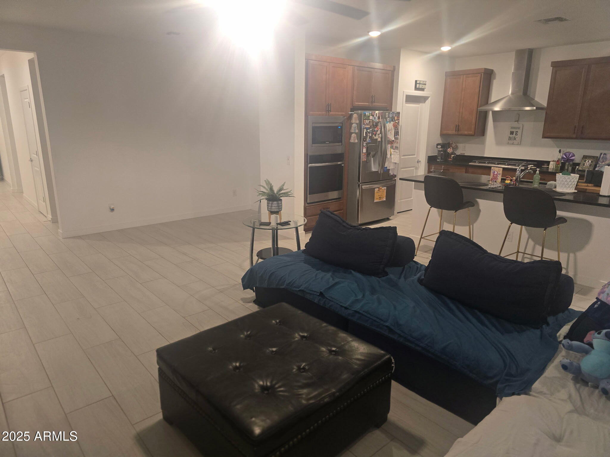 17446 West Fulton Street Goodyear, AZ 85338 - Photo 11 of 16 a living room with furniture and a view of kitchen appliances