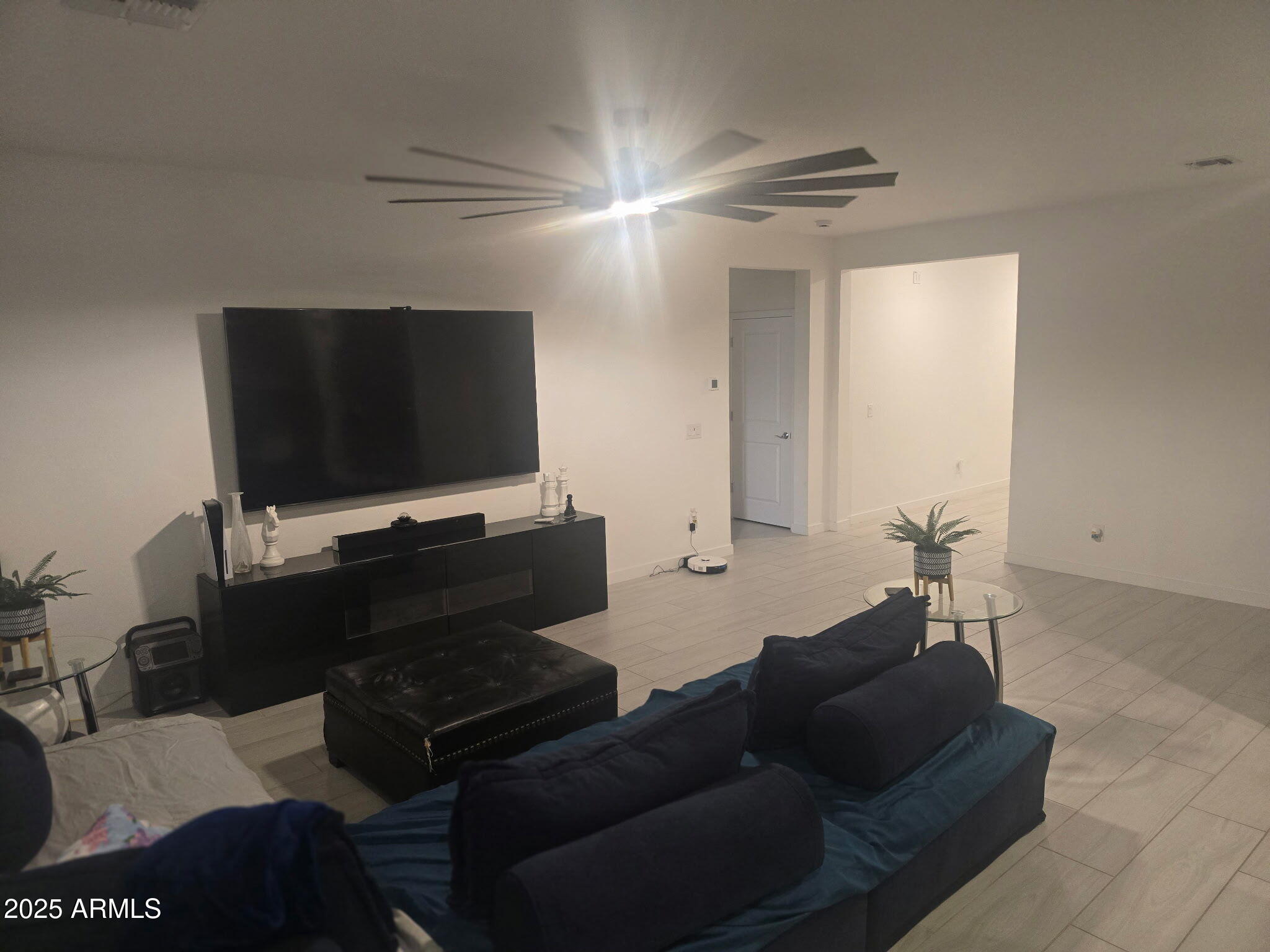 17446 West Fulton Street Goodyear, AZ 85338 - Photo 13 of 16 a living room with furniture and a flat screen tv