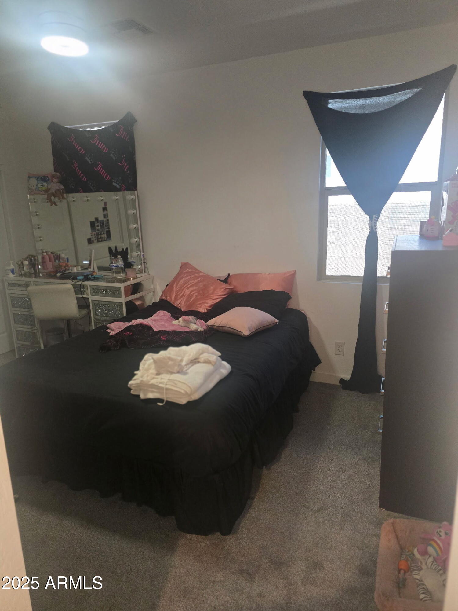 17446 West Fulton Street Goodyear, AZ 85338 - Photo 9 of 16 a bed sitting in a bedroom next to a window