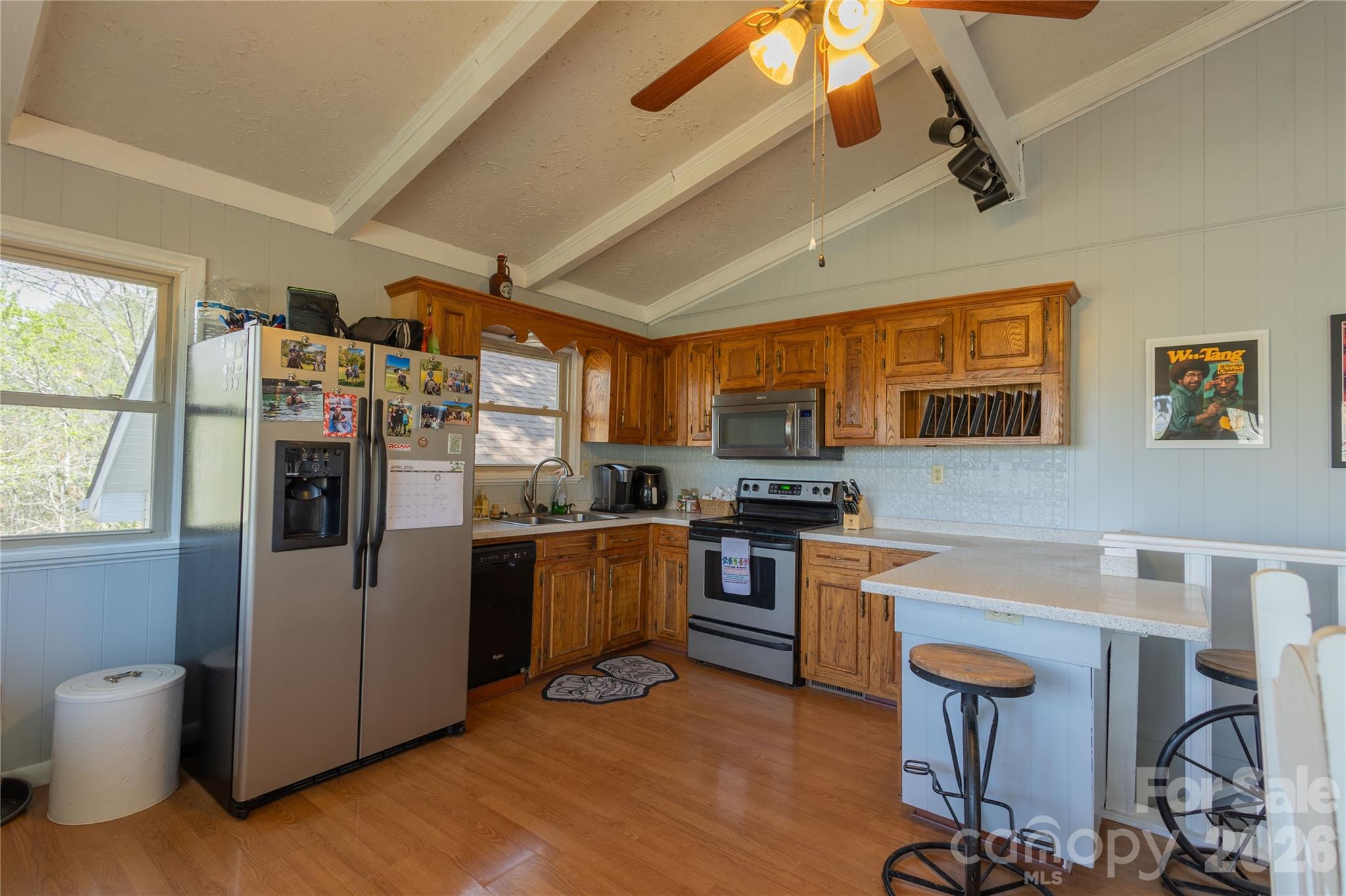 344 Pine Ridge Trail Almond, NC 28702 - Photo 13 of 36 a kitchen with stainless steel appliances granite countertop a refrigerator a stove top oven a sink dishwasher and white cabinets with wooden floor