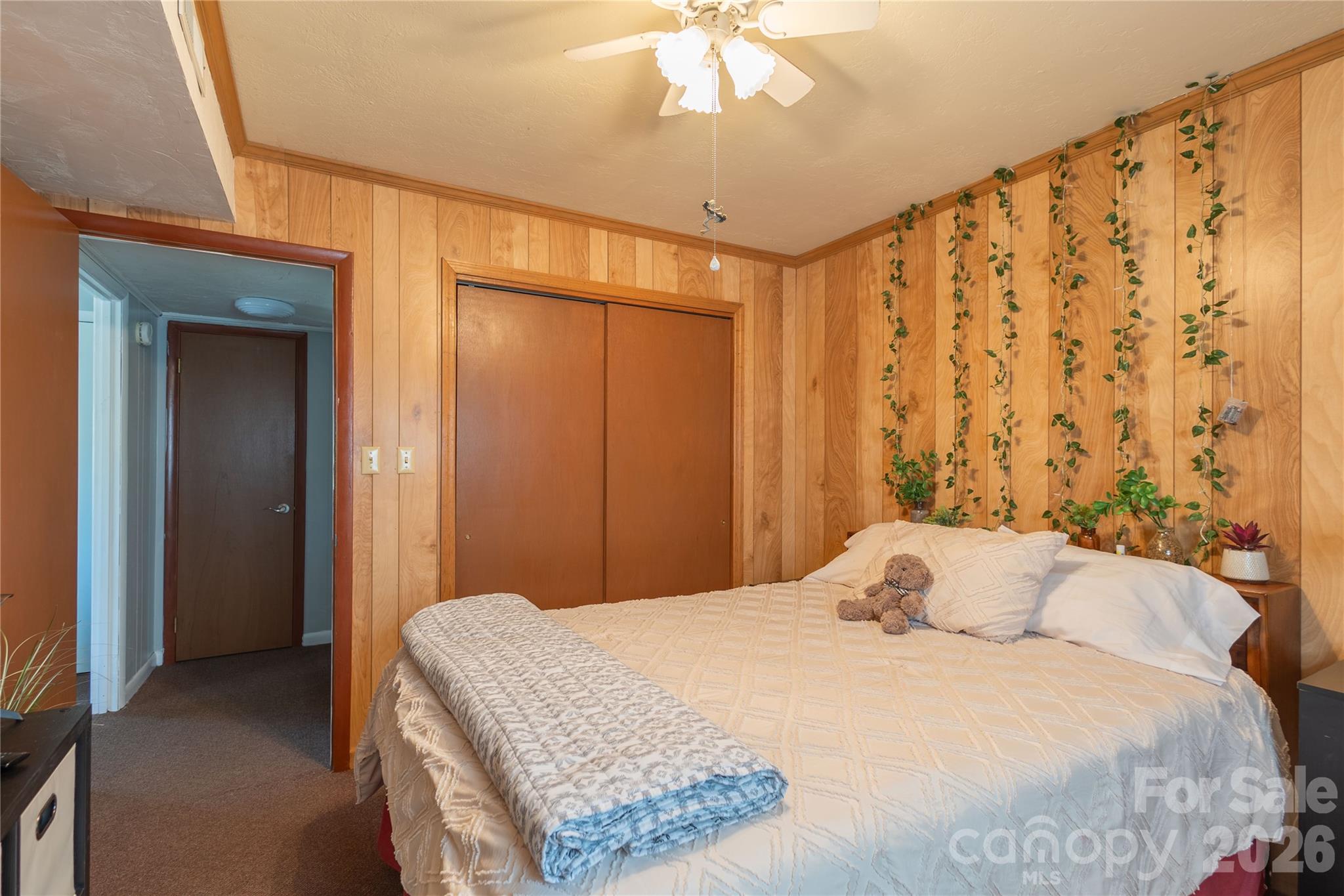 344 Pine Ridge Trail Almond, NC 28702 - Photo 10 of 36 a bedroom with a large bed and a chandelier