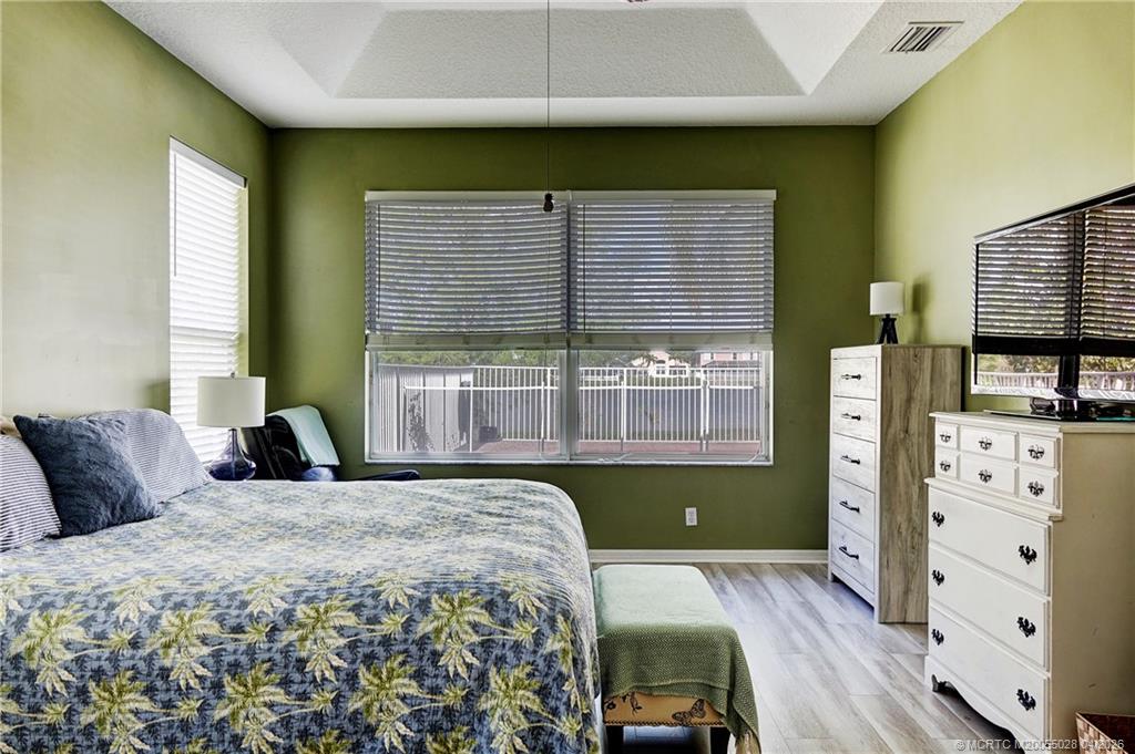 2120 Northwest Marsh Rabbit Lane Jensen Beach, FL 34957 - Photo 20 of 34 a bedroom with a bed and a window