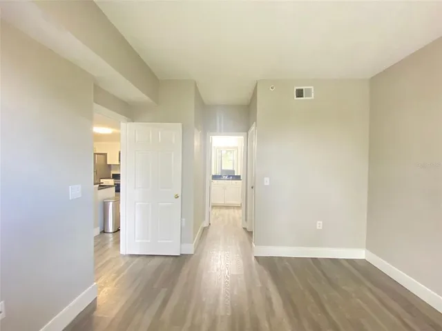 a view of wooden floor and windows in a room