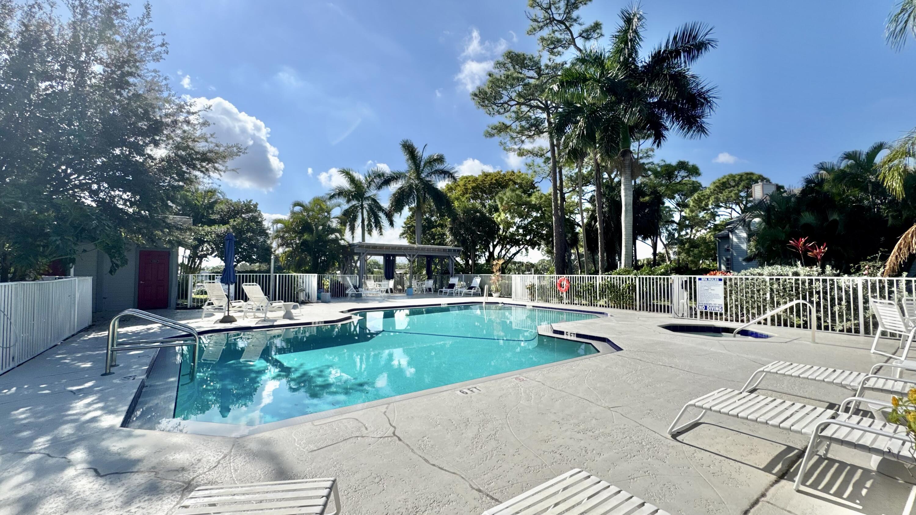 5016 Heatherhill Lane, Unit 10 Boca Raton, FL 33486 - Photo 11 of 12 a view of a swimming pool with a patio