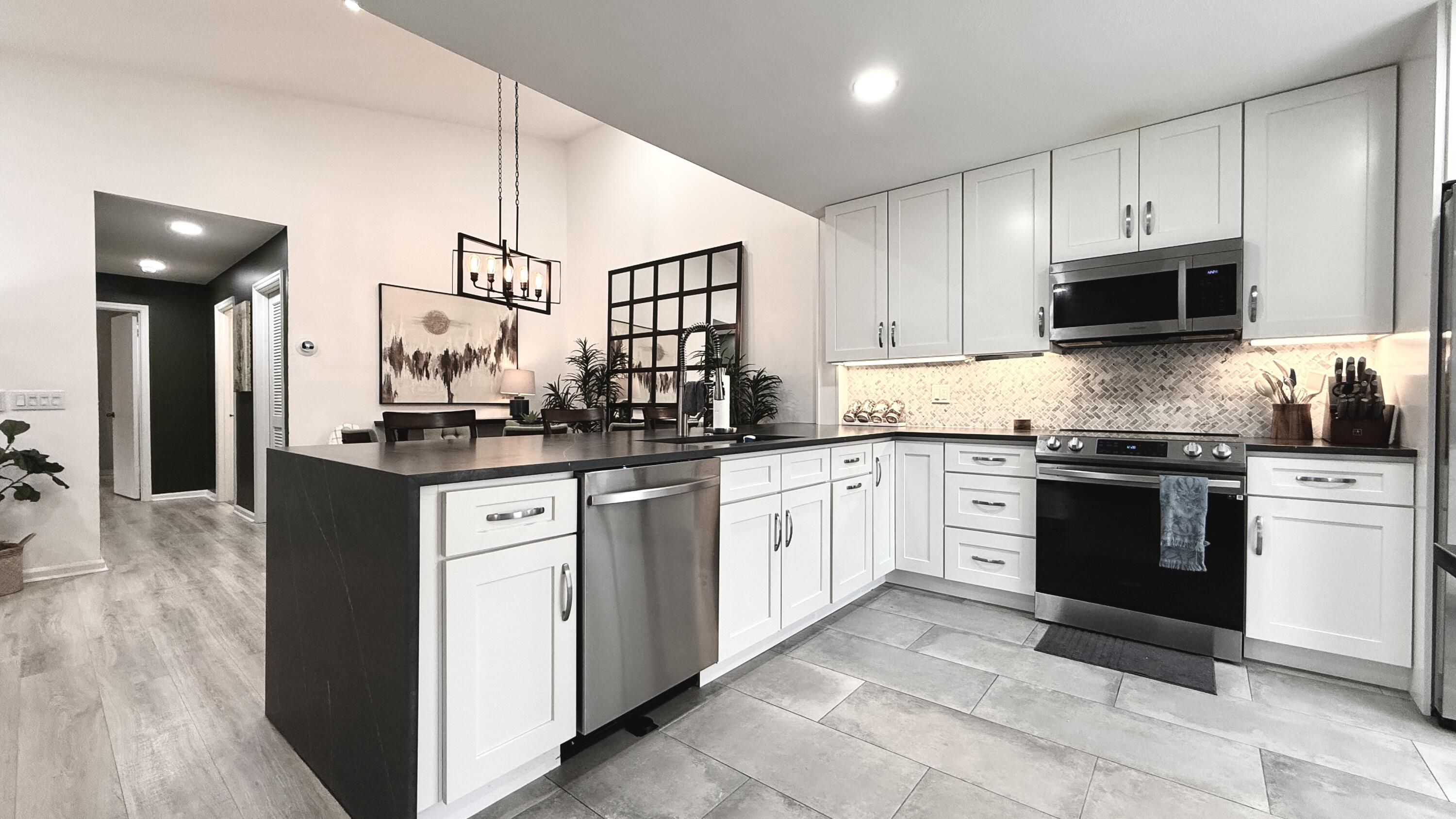 5016 Heatherhill Lane, Unit 10 Boca Raton, FL 33486 - Photo 4 of 12 a kitchen with stainless steel appliances granite countertop a refrigerator and a stove top oven