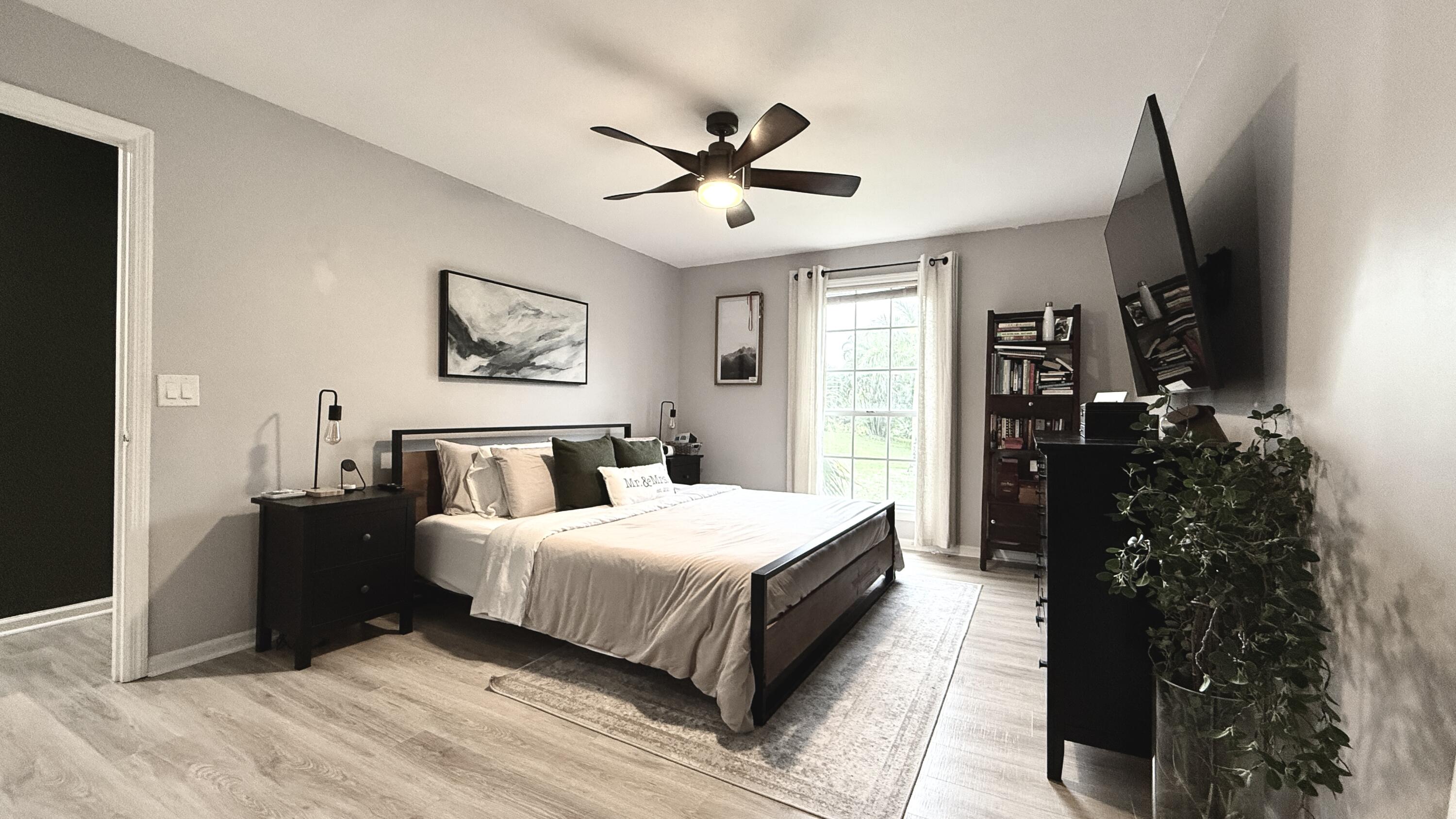 5016 Heatherhill Lane, Unit 10 Boca Raton, FL 33486 - Photo 6 of 12 a bed room with a bed window and a flat screen tv