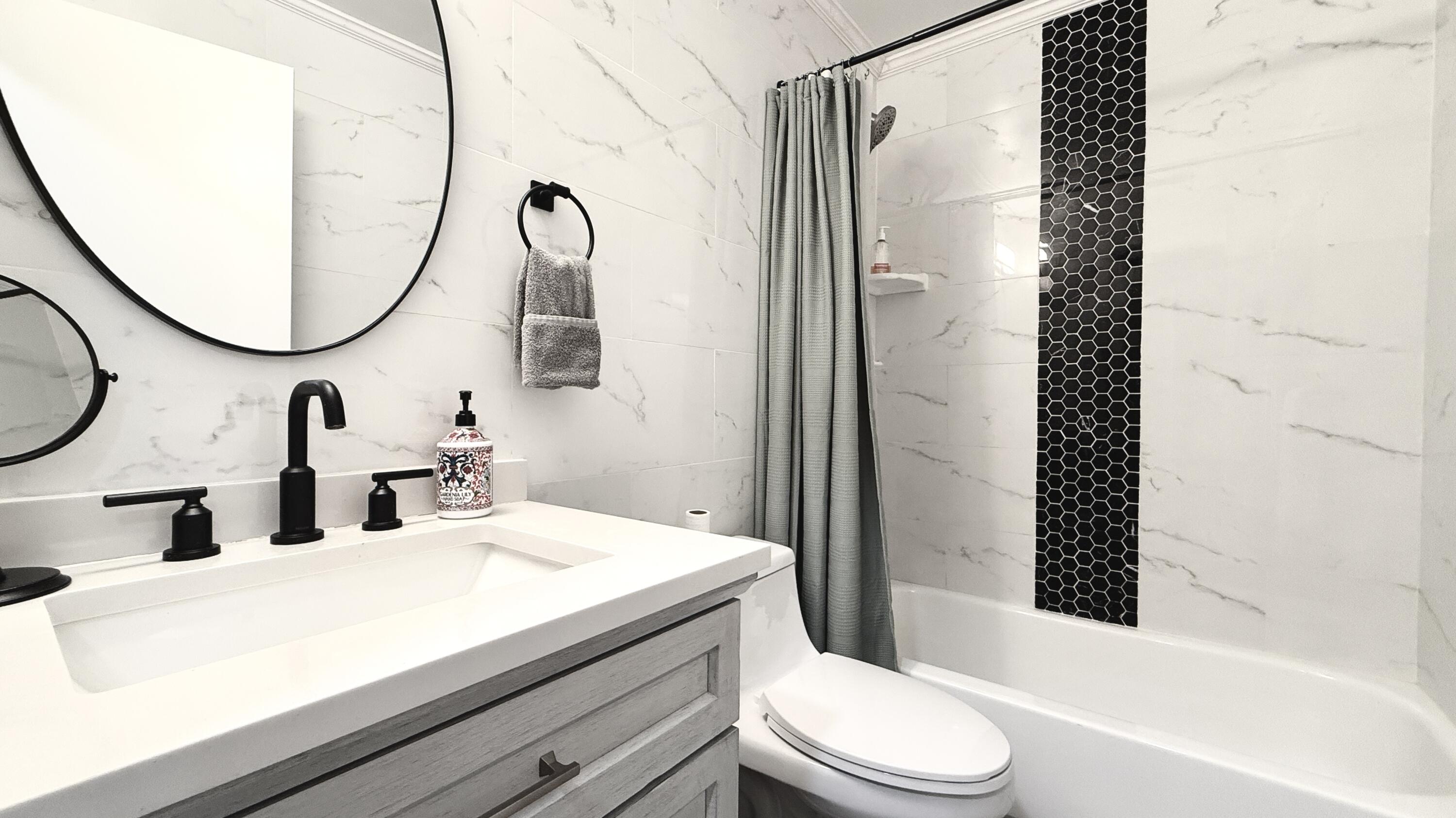 5016 Heatherhill Lane, Unit 10 Boca Raton, FL 33486 - Photo 9 of 12 a bathroom with a sink a toilet and a mirror