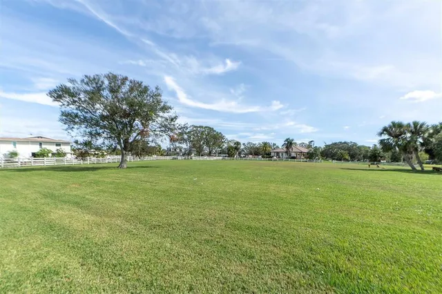 a view of a field of grass and trees