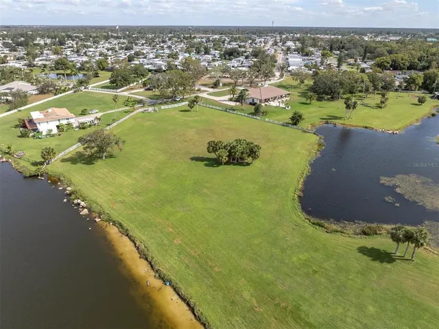 an aerial view of a residential houses with outdoor space