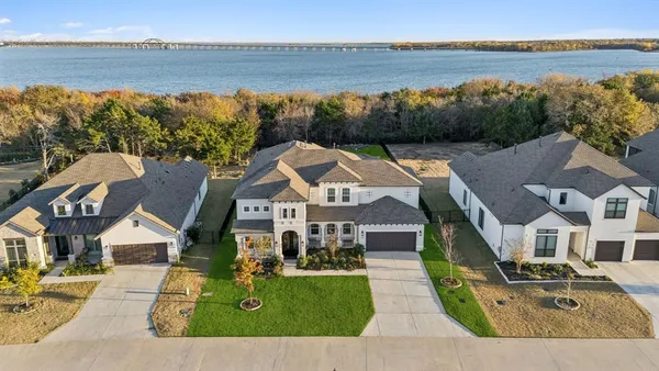 an aerial view of a house with a garden and lake view