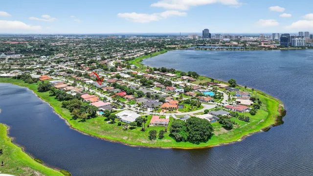 a front view of a house with a yard and potted plants