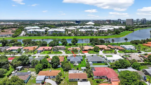 an aerial view of residential houses with outdoor space and lake view