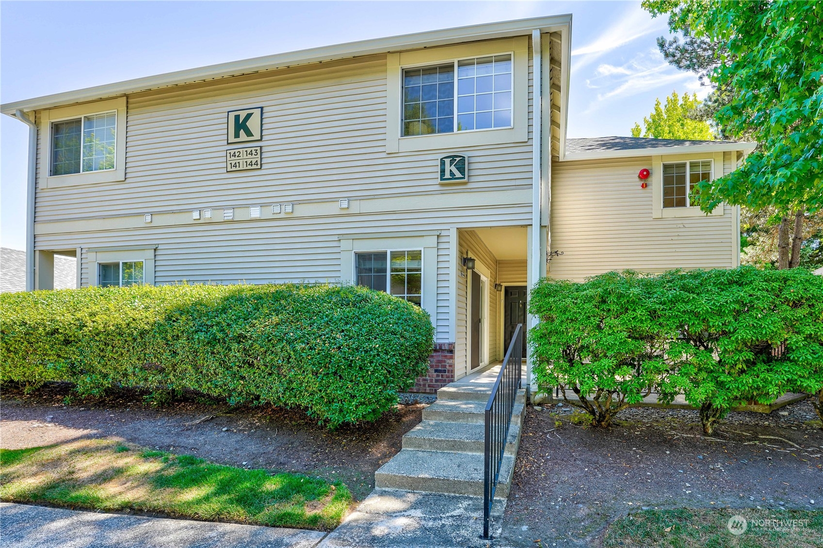 10909 Avondale Road Northeast, Unit K144 Redmond, WA 98052 - Photo 1 of 28 a front view of a house with garden