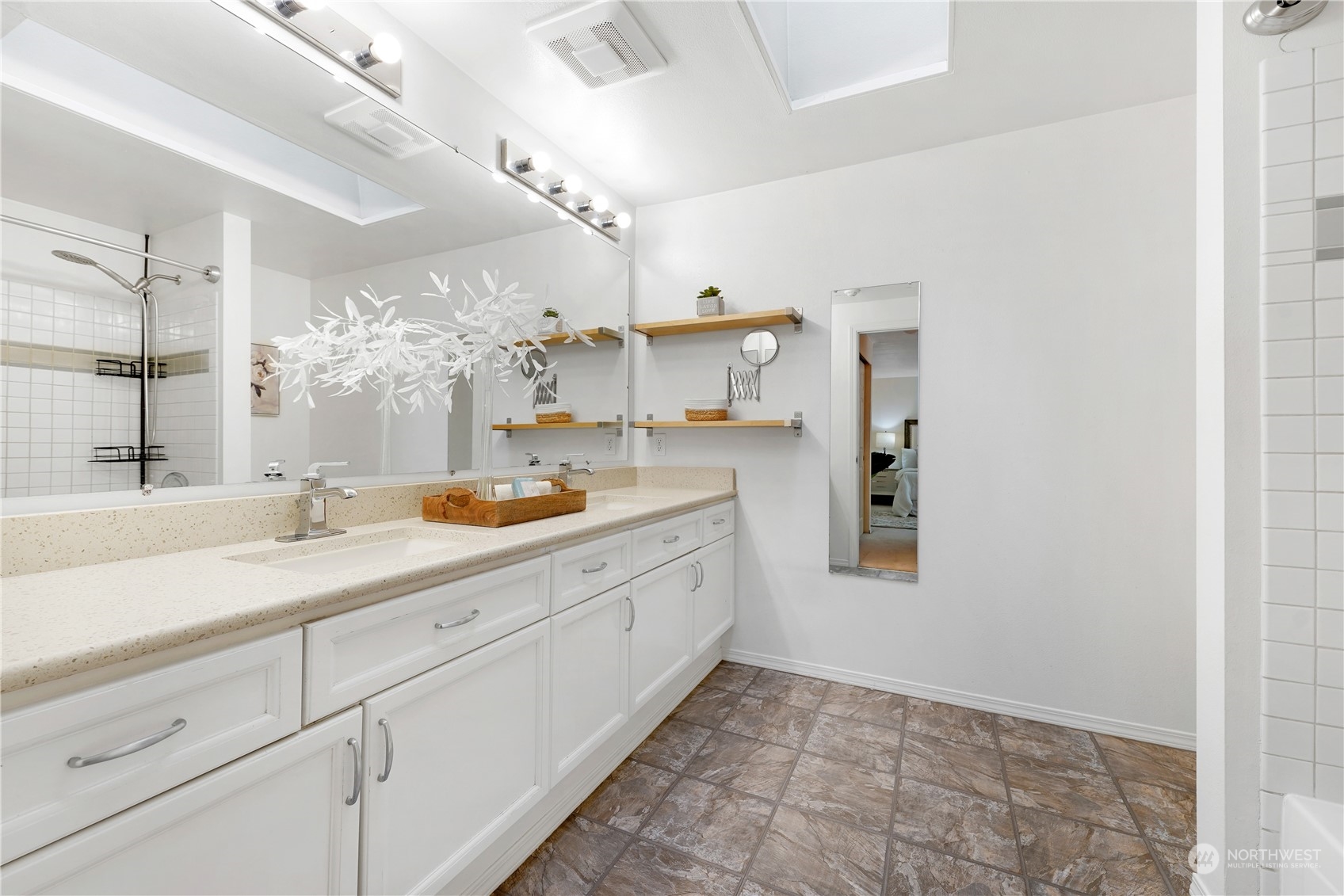 10909 Avondale Road Northeast, Unit K144 Redmond, WA 98052 - Photo 21 of 28 a spacious bathroom with a granite countertop sink mirror and