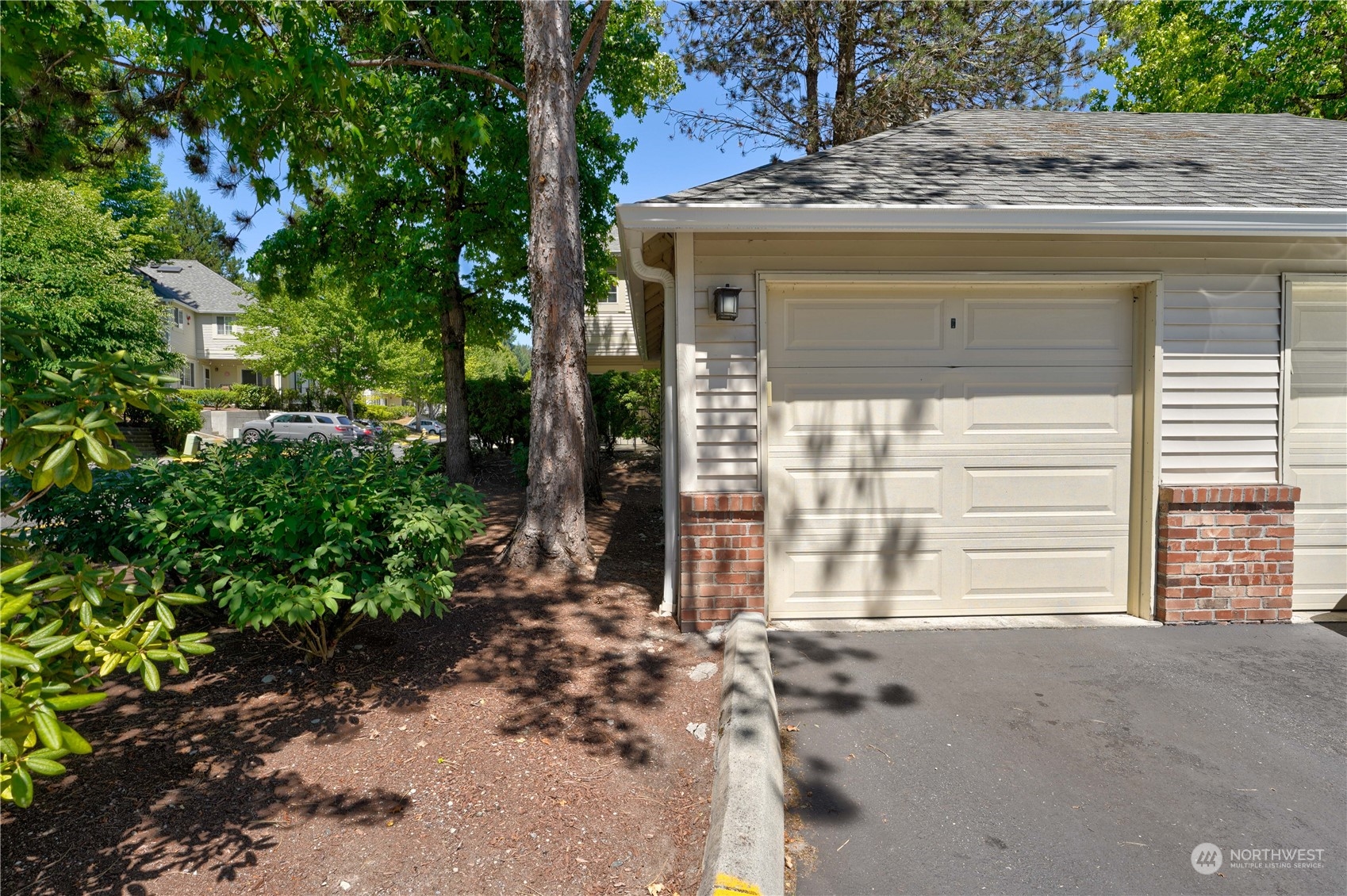 10909 Avondale Road Northeast, Unit K144 Redmond, WA 98052 - Photo 3 of 28 a view of a house with a door and a tree