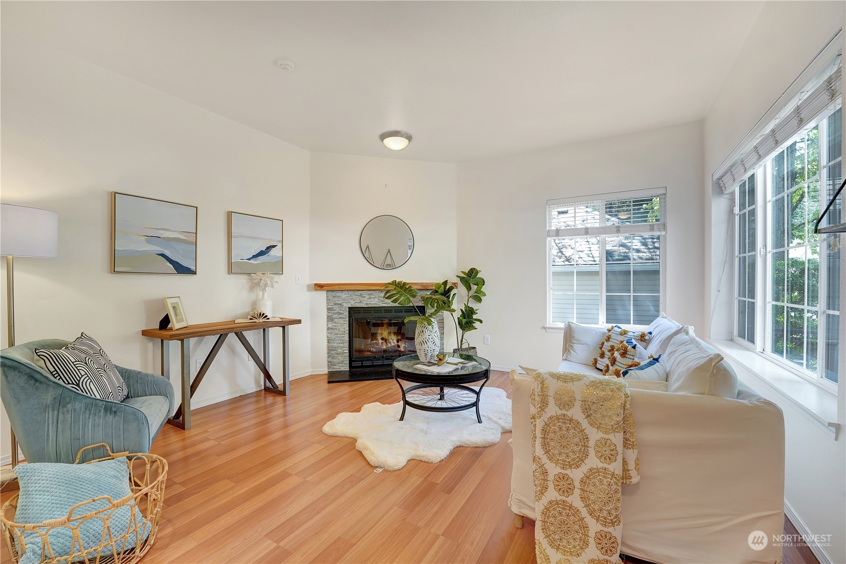 10909 Avondale Road Northeast, Unit K144 Redmond, WA 98052 - Photo 5 of 28 a living room with furniture a fireplace and a floor to ceiling window
