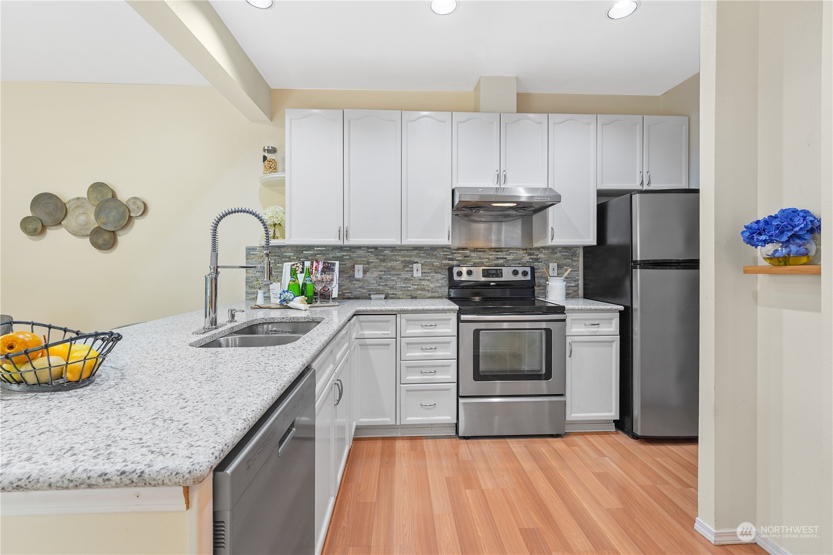 10909 Avondale Road Northeast, Unit K144 Redmond, WA 98052 - Photo 10 of 28 a kitchen with a sink cabinets and stainless steel appliances