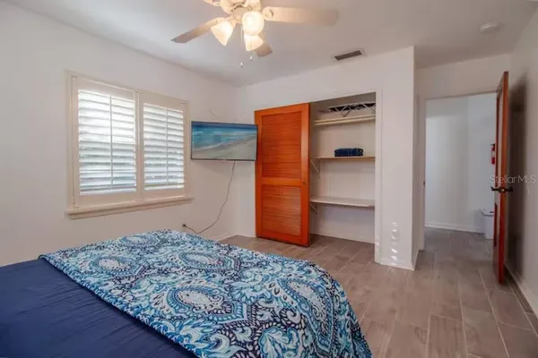 a bedroom with a bed and a window