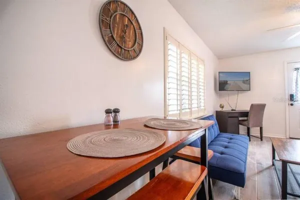 a view of a dining room with furniture and a window
