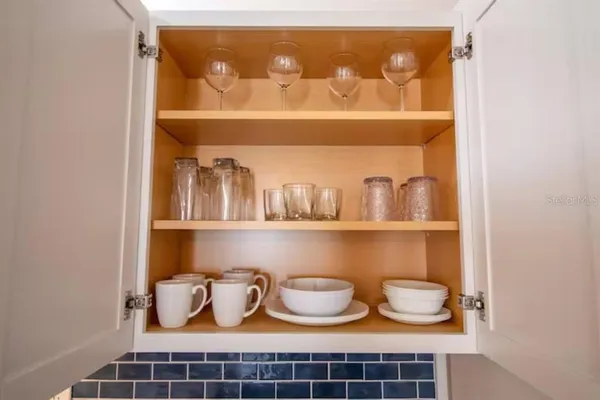 a shelf with cup and plates