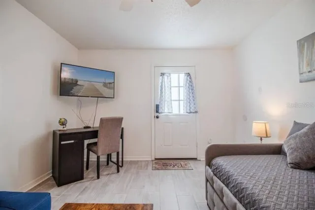 a bedroom with a bed and a desk