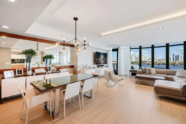 a kitchen with stainless steel appliances kitchen island granite countertop a table and chairs