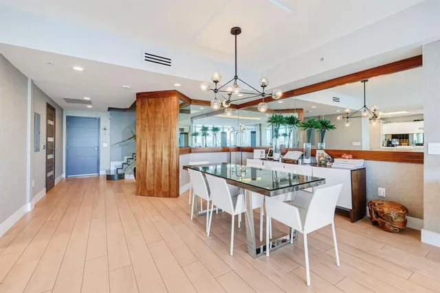 a kitchen with kitchen island a counter top space a sink stainless steel appliances and cabinets