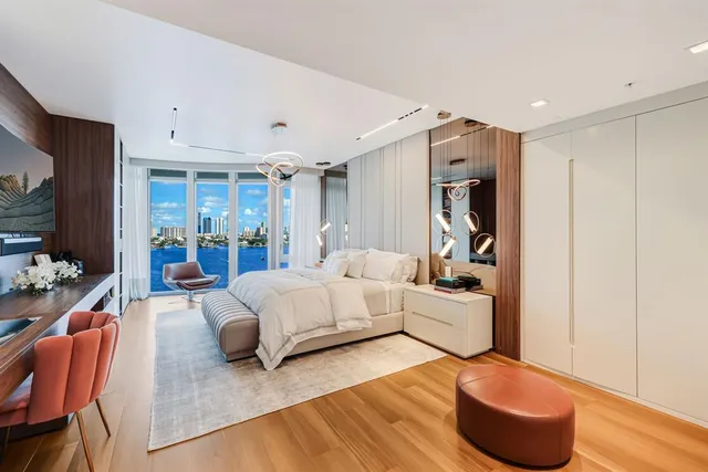 a bathroom with a toilet sink vanity granite and shower