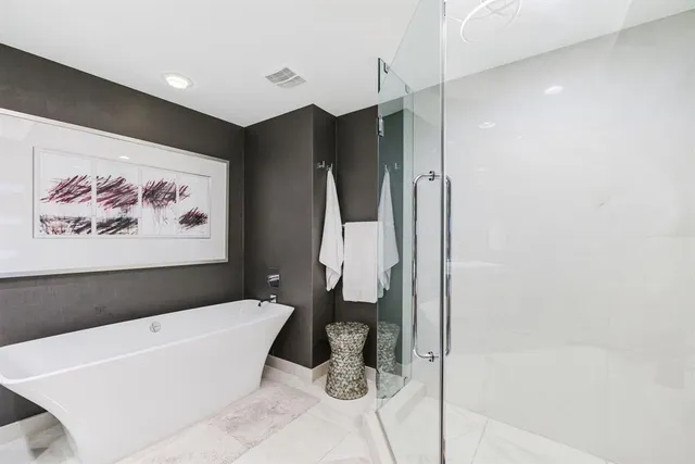 a living room with furniture a flat screen tv and a floor to ceiling window